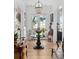 Inviting entryway with hardwood floors, a round center table and a view to the water and marsh through the front door at 1456 Mcpherson Lndg, Johns Island, SC 29455