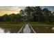 A beautiful home surrounded by trees viewed from the dock at 1456 Mcpherson Lndg, Johns Island, SC 29455