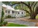 Charming home with a metal roof, inviting porch, and mature trees at 1456 Mcpherson Lndg, Johns Island, SC 29455