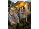 Inviting front porch featuring well-lit stairs, decorative plants, and classic architectural details at 1456 Mcpherson Lndg, Johns Island, SC 29455