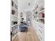 Hallway lined with bookshelves and storage, hardwood flooring, blue sitting chairs at 1456 Mcpherson Lndg, Johns Island, SC 29455