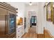 Hallway with stainless steel refrigerator and gourmet kitchen at 1456 Mcpherson Lndg, Johns Island, SC 29455