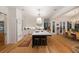 Open-concept kitchen with a large island, marble countertops, stainless appliances and an adjacent dining area at 1456 Mcpherson Lndg, Johns Island, SC 29455