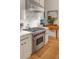 Bright kitchen featuring a stainless steel Wolf range, marble backsplash and countertops and custom white cabinets at 1456 Mcpherson Lndg, Johns Island, SC 29455