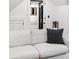 A comfortable white couch is accentuated by a stylish, striped throw pillow at 1456 Mcpherson Lndg, Johns Island, SC 29455
