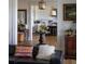 Open-concept living room with hardwood floors, a black leather couch, and a view into the kitchen at 1456 Mcpherson Lndg, Johns Island, SC 29455