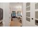 Hallway with view of a living room featuring hardwood floors, large windows, and natural light at 1456 Mcpherson Lndg, Johns Island, SC 29455
