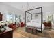 Spacious bedroom with natural light, four-poster bed, and hardwood floors at 1456 Mcpherson Lndg, Johns Island, SC 29455
