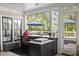 Outdoor kitchen with marble counters, stainless steel grill, and views of the pool and backyard at 1456 Mcpherson Lndg, Johns Island, SC 29455
