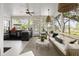 Inviting screened porch boasts outdoor kitchen, comfortable seating, and views of the surrounding greenery at 1456 Mcpherson Lndg, Johns Island, SC 29455