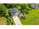 Aerial view of a home with a well-manicured lawn, gray roof, and long driveway at 1617 Southwick Dr, Johns Island, SC 29455