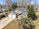 Aerial view of a lovely home featuring a large driveway, a well-maintained lawn, and mature trees at 1617 Southwick Dr, Johns Island, SC 29455