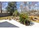 Beautiful backyard with a fire pit, two Adirondack chairs, lush landscaping, and wooden fencing at 1617 Southwick Dr, Johns Island, SC 29455