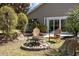 Charming backyard featuring a stone fire pit and comfortable seating area, great for outdoor gatherings at 1617 Southwick Dr, Johns Island, SC 29455