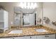Bathroom features a double vanity with granite countertops and decorative mirror at 1617 Southwick Dr, Johns Island, SC 29455