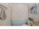Bathroom featuring a sand and shell theme, with sea-themed shower curtain and nautical wall art at 1617 Southwick Dr, Johns Island, SC 29455