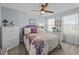 Bright bedroom with carpet, ceiling fan, two large windows with curtains, and white wicker night stands at 1617 Southwick Dr, Johns Island, SC 29455