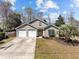 Charming home with well-manicured lawn, a two-car garage, and a welcoming facade, radiating curb appeal at 1617 Southwick Dr, Johns Island, SC 29455