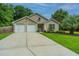 Charming single-Gathering home with a well-manicured lawn, palm tree, and attached two-car garage at 1617 Southwick Dr, Johns Island, SC 29455