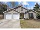 Charming single Gathering home with a yellow front door, two-car garage, and well-maintained lawn at 1617 Southwick Dr, Johns Island, SC 29455