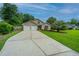 Charming single-Gathering home with a well-manicured lawn, palm tree, and attached two-car garage at 1617 Southwick Dr, Johns Island, SC 29455
