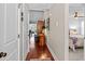Inviting hallway with hardwood floors and views into the living room and main bedroom at 1617 Southwick Dr, Johns Island, SC 29455