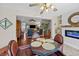 Open-concept living space with dining area and modern fireplace featuring hardwood floors and modern furniture at 1617 Southwick Dr, Johns Island, SC 29455