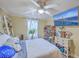 Relaxing bedroom with mounted TV, ceiling fan, and large window bringing in plenty of light at 1644 Cooper Store Rd, Moncks Corner, SC 29461
