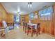 Comfortable dining room features wood-paneled walls and a view of the living area at 1644 Cooper Store Rd, Moncks Corner, SC 29461