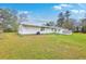 Rear exterior view of home showcasing a well-maintained lawn, storage shed, and classic architecture at 1644 Cooper Store Rd, Moncks Corner, SC 29461
