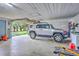 Spacious garage featuring an SUV parked inside, showcasing ample room for vehicle storage and additional storage at 1644 Cooper Store Rd, Moncks Corner, SC 29461