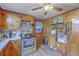 Cozy kitchen with wood cabinets, stainless steel stove and microwave, and convenient door access at 1644 Cooper Store Rd, Moncks Corner, SC 29461