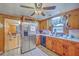 Bright kitchen with stainless steel refrigerator, wood cabinets, and views into the living area at 1644 Cooper Store Rd, Moncks Corner, SC 29461