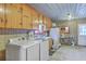 Functional laundry room features a washer and dryer, ample cabinet space, and a utility sink for added convenience at 1644 Cooper Store Rd, Moncks Corner, SC 29461