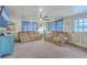 Living room with comfortable couches, ceiling fan, and natural light creating an inviting atmosphere at 1644 Cooper Store Rd, Moncks Corner, SC 29461
