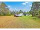 Expansive property showcasing a home, lush green lawn, mature trees, and multiple vehicles parked in the driveway at 1644 Cooper Store Rd, Moncks Corner, SC 29461