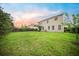 Large, grassy backyard with a wooden fence and covered patio area at 166 Pavilion St, Summerville, SC 29483