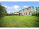Large, grassy backyard with a wooden fence and covered patio area at 166 Pavilion St, Summerville, SC 29483