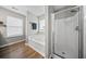 Bright bathroom with jacuzzi tub, standing shower, and wood-look flooring at 166 Pavilion St, Summerville, SC 29483