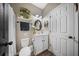 Cozy bathroom with an oval mirror, decorative wall wreath, and convenient toilet at 166 Pavilion St, Summerville, SC 29483