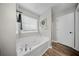 Bright bathroom with a soaking tub and large window at 166 Pavilion St, Summerville, SC 29483