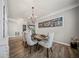 Elegant dining room has a chandelier, modern decor, and seamlessly connects to other living areas at 166 Pavilion St, Summerville, SC 29483