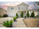 Charming two-story home features a well-manicured front yard, inviting entryway, and attached garage at 166 Pavilion St, Summerville, SC 29483