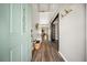Bright foyer featuring wood floors, coat hooks, bench, and an open view into other living spaces at 166 Pavilion St, Summerville, SC 29483
