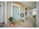 Inviting front porch with rocking chairs, potted plants and welcoming decor at 166 Pavilion St, Summerville, SC 29483
