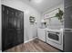 Functional laundry room includes washer, dryer, folding counter, and decorative wall art at 166 Pavilion St, Summerville, SC 29483