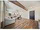 Open-concept living room with exposed beam, ceiling fan, and staircase leading to the second floor at 166 Pavilion St, Summerville, SC 29483