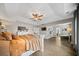 Bright main bedroom featuring tray ceiling, ceiling fan, and sitting area at 166 Pavilion St, Summerville, SC 29483