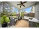 Inviting covered patio with wicker furniture, ceiling fan, and string lights at 166 Pavilion St, Summerville, SC 29483