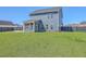 Spacious backyard with a manicured lawn, a screened-in porch, and fenced perimeter at 175 Darby Meadow Ln, Ridgeville, SC 29472